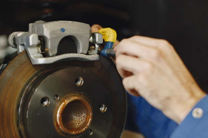 Mechanic inspecting disc brake