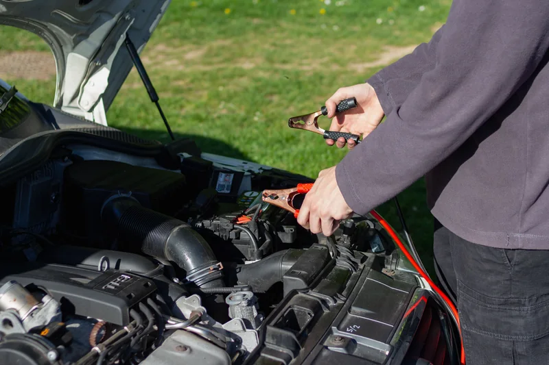 Jumper cables at a car battery