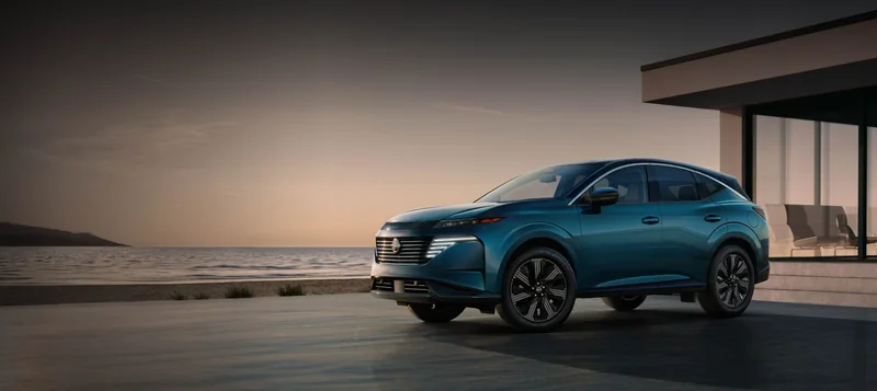 Blue Murano parked outside an oceanside home at dusk