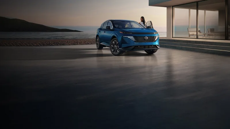 Blue Murano driving through a modern urban setting