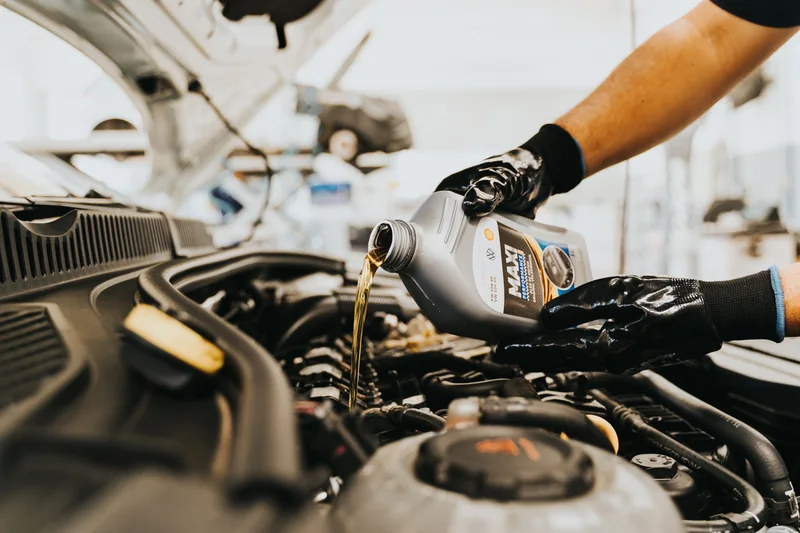 Mechanic pouring engine oil