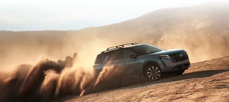 Pathfinder accelerating through sandy desert terrain at sunset