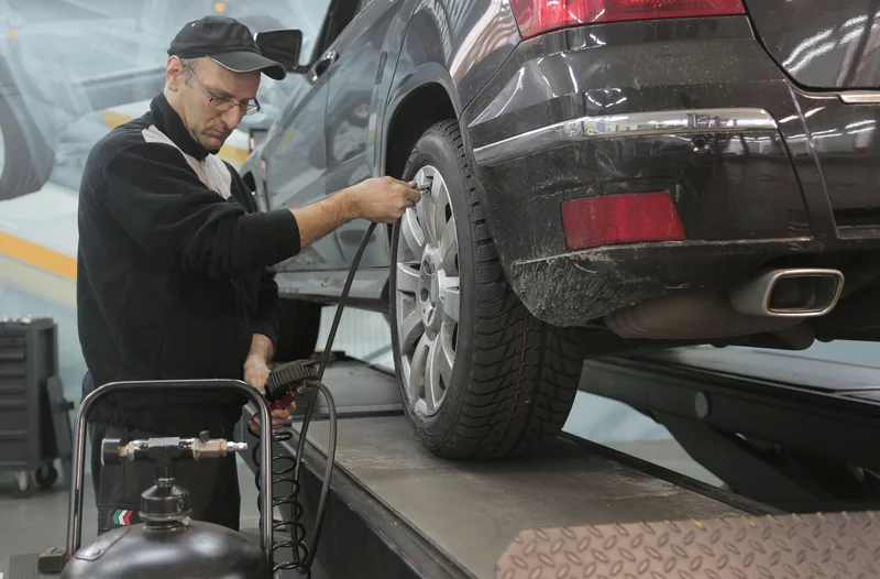 Mechanic checking tire pressure